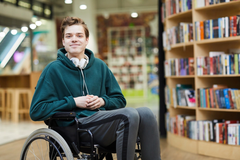 Disabled men in wheelchair in a library