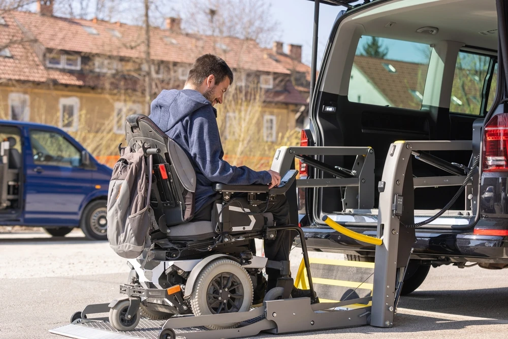Disabled men on wheelchair getting on a van
