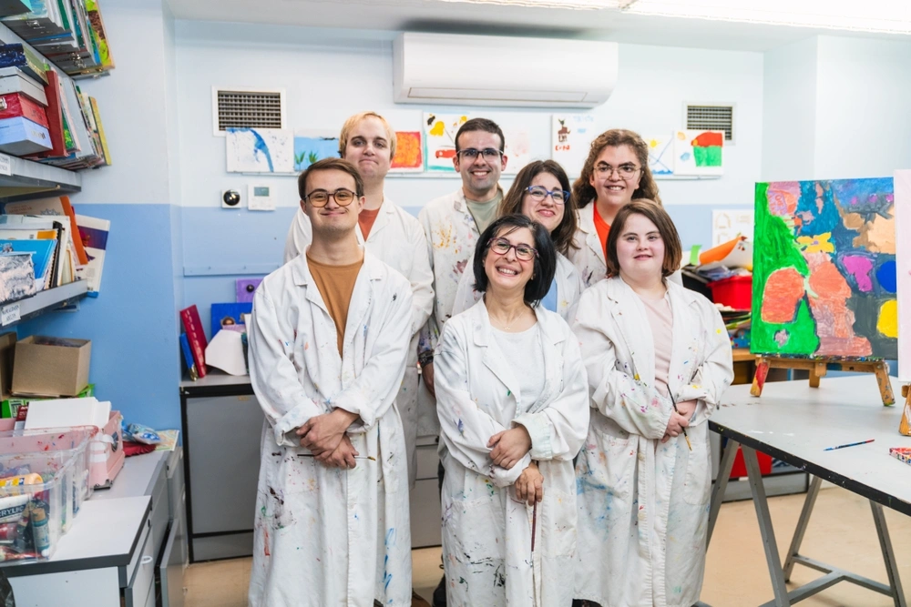 Group of friends with disabilities in a painting class