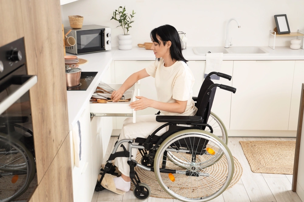 Disabled women on wheelchair cooking food