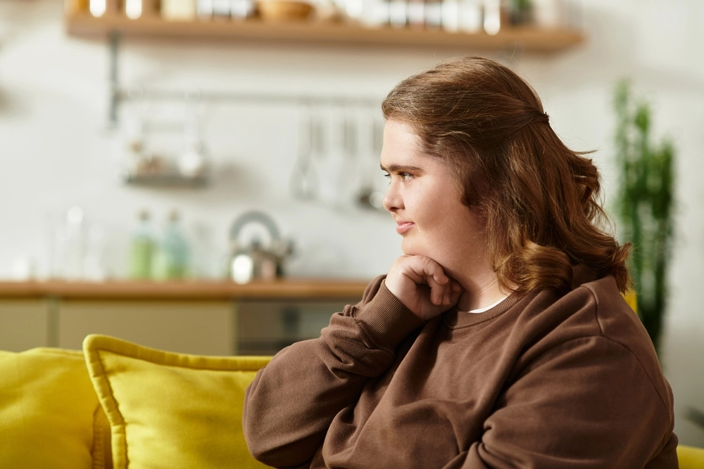 Disabled down syndrome women sitting on sofa